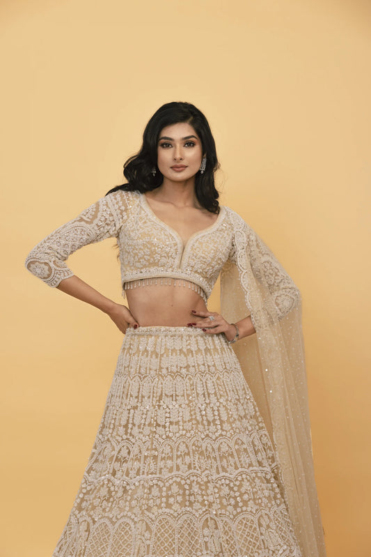 Beige net lehenga with pearl embellishments