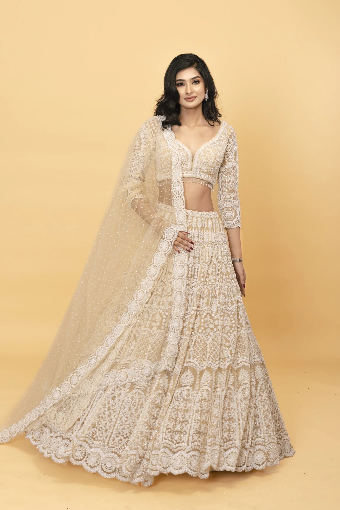 Beige net lehenga with pearl embellishments