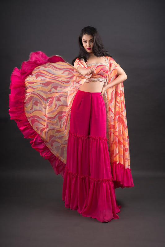 Hot pink Gharara Pants paired with abstract printed crop-top and long cape