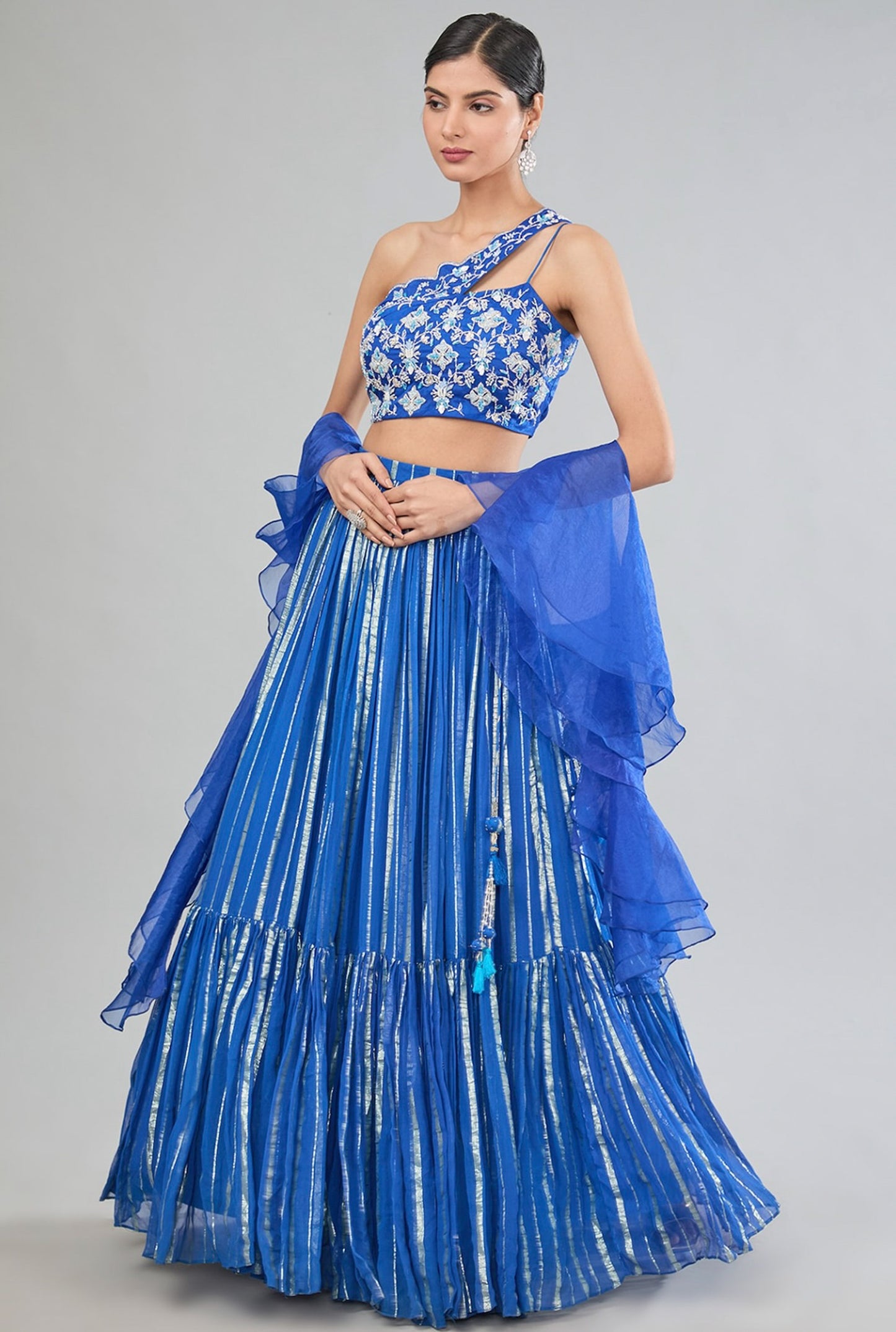 Blue Georgette tier lehenga with one shoulder blouse and dupatta