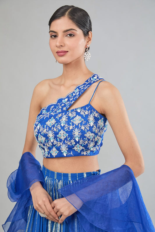 Blue Georgette tier lehenga with one shoulder blouse and dupatta