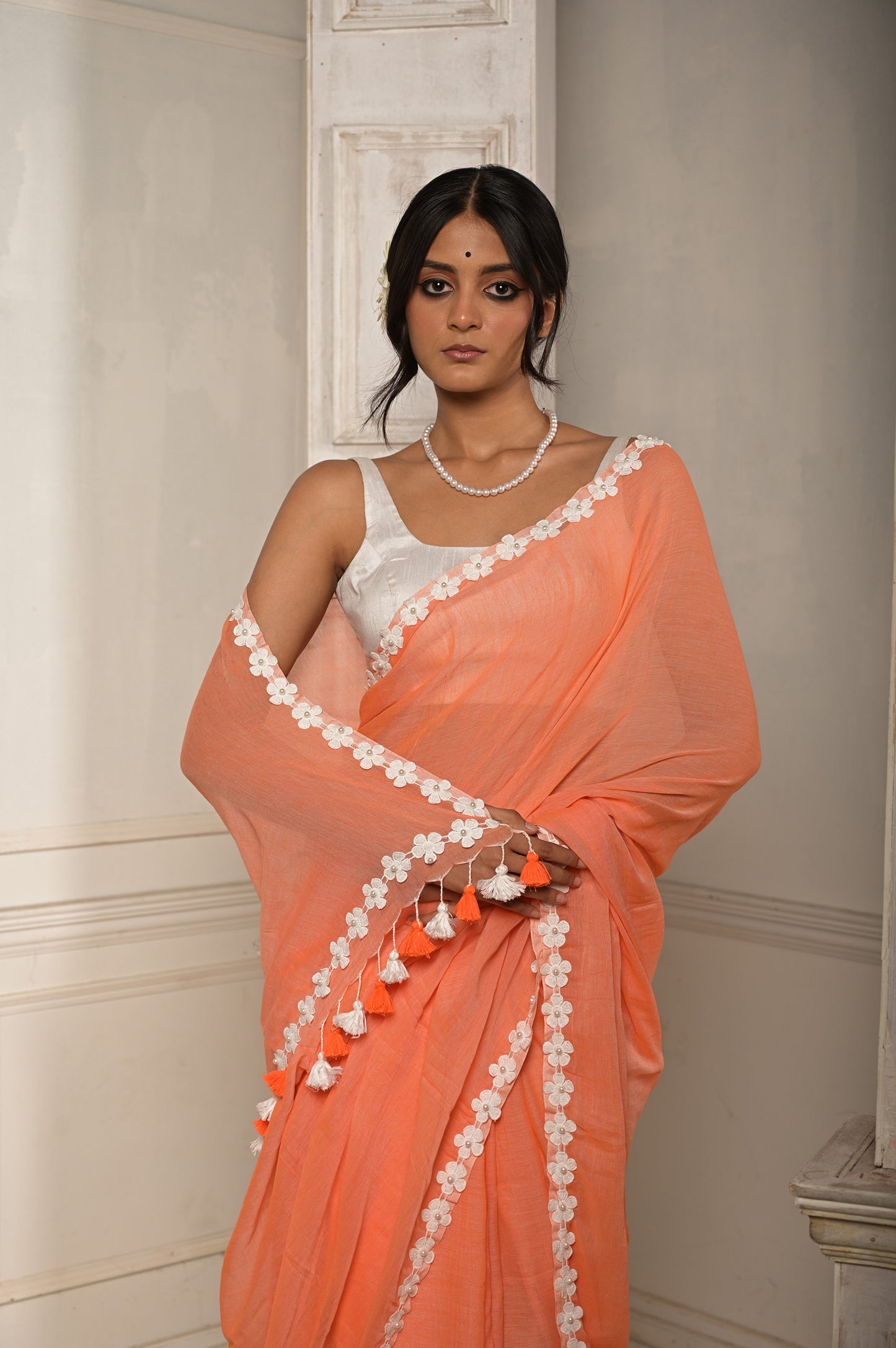 Surbhi shaam | Peach Pink cotton saree with stitched lace floral embroidered border