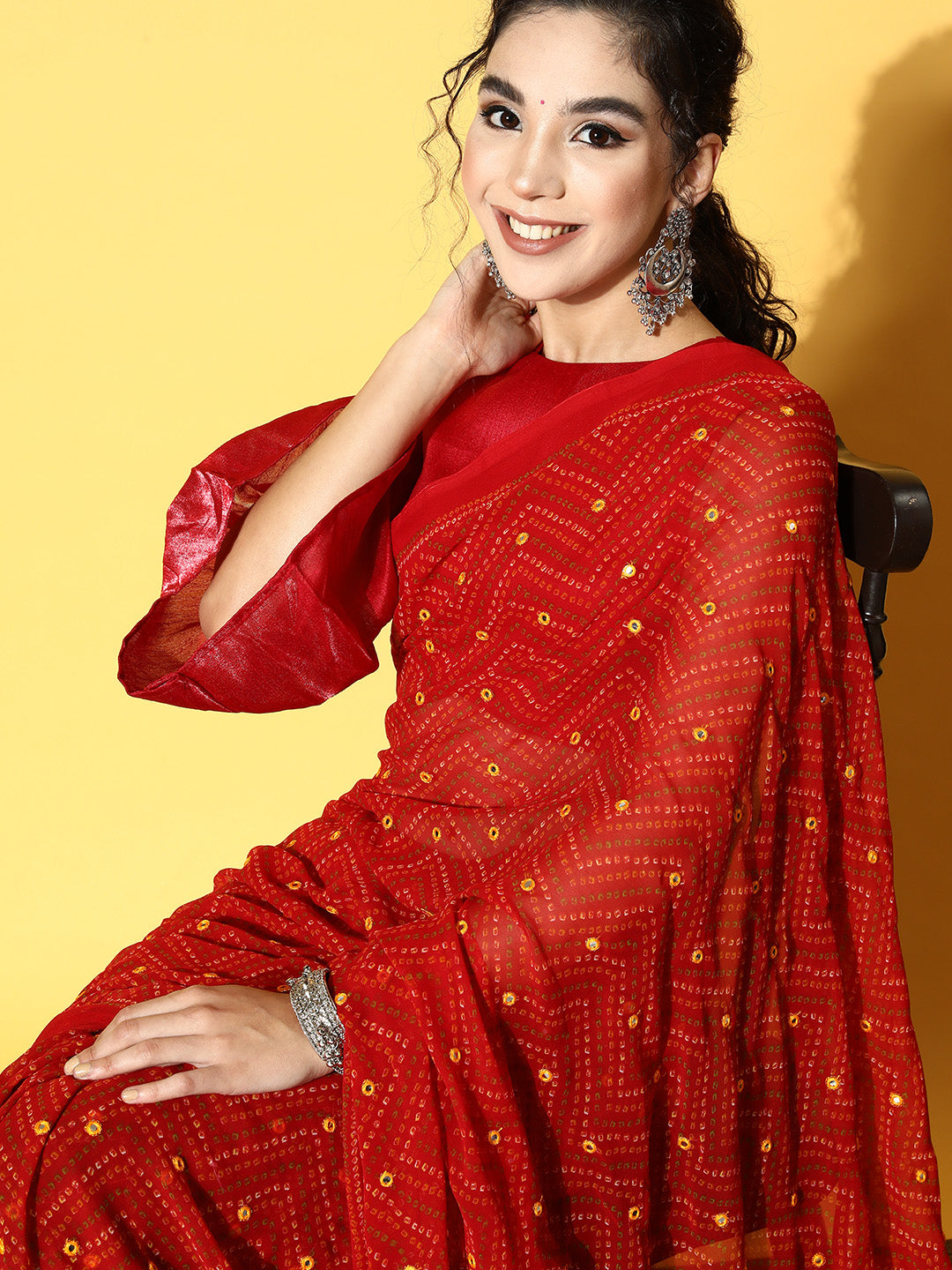 Red colored Bandhani polyester georgette saree with mirror work