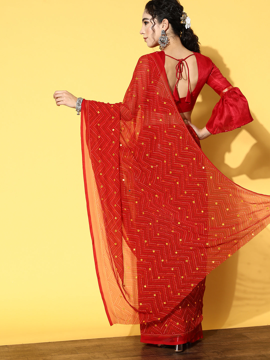 Red colored Bandhani polyester georgette saree with mirror work