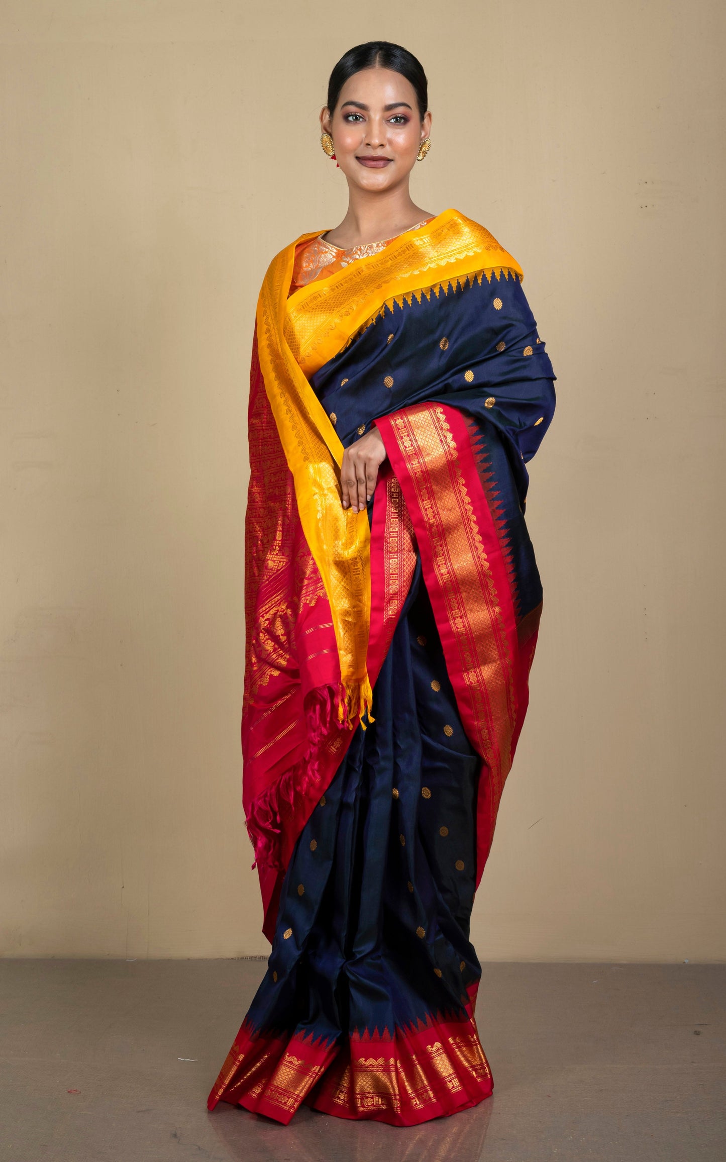 Exclusive Gadwal Silk Saree in Ink Blue, Saffron Yellow, Bright Red and Golden Zari Weave